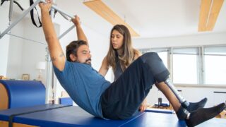a woman guiding a man in rehabilitation