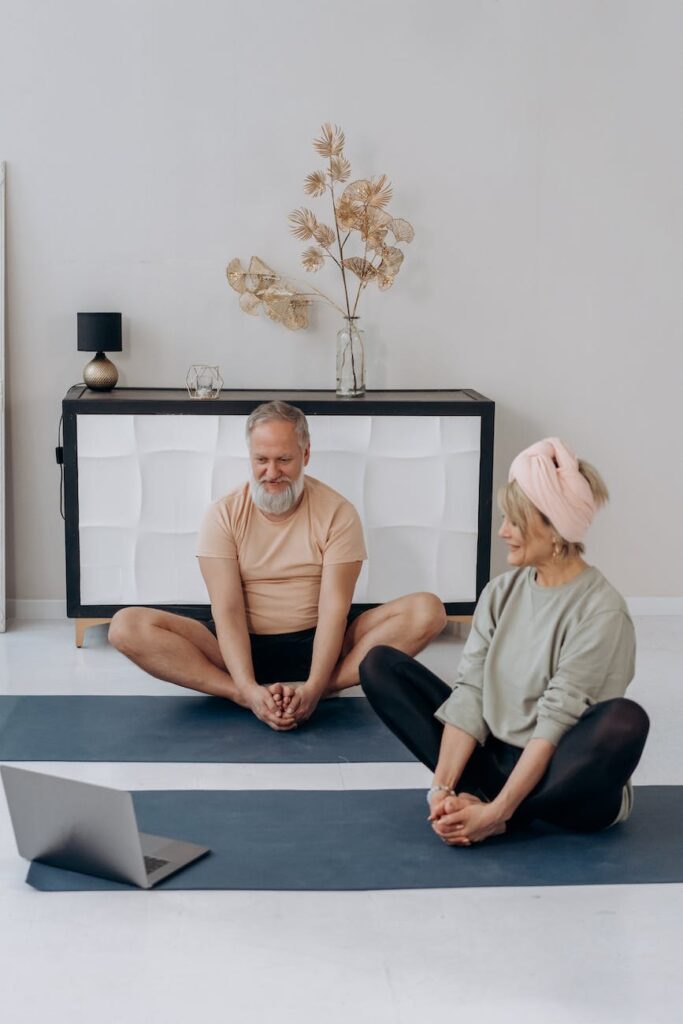 elderly couple exercising together at home